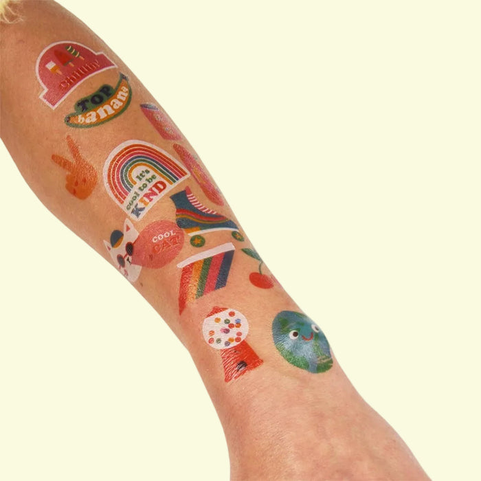 Colorful temporary tattoos on a person's arm with various designs.