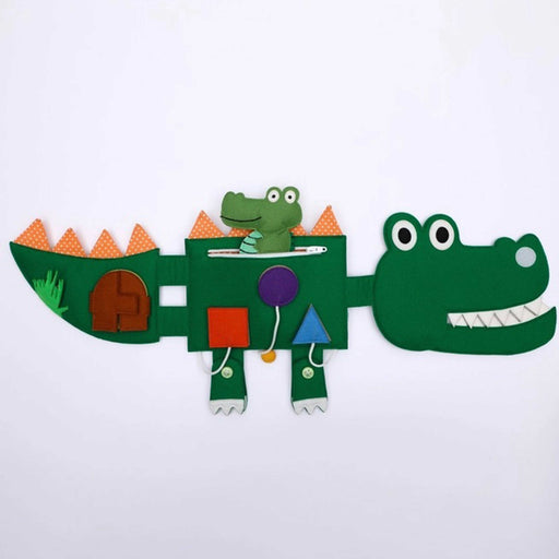 green felt toy crocodile toy with two feet, tail, orange trianles along back and mini crocodile sitting n a zipped pocket on crocodile's body