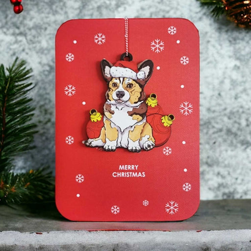 red christmas card with wooden corgi dog in xmas hat decoration
