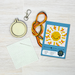 Embroidery kit with hoop, thread, and pattern card on a wooden surface