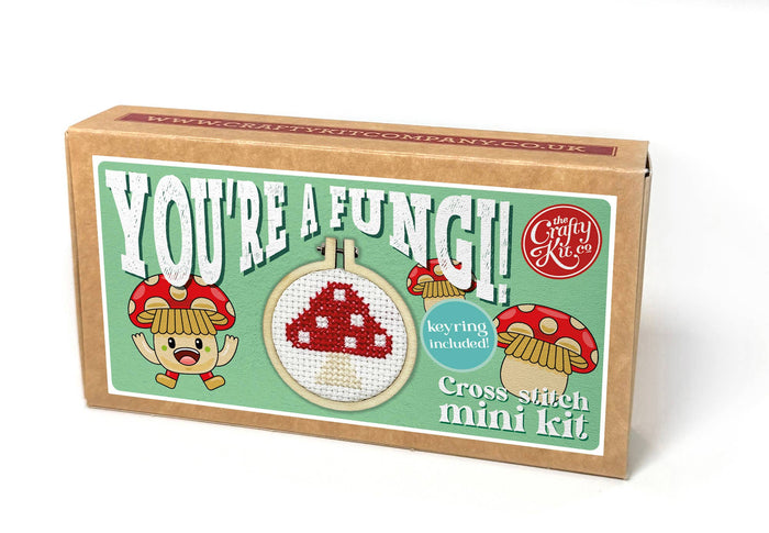 Cross-stitch mini kit packaging with cartoon mushrooms and text on a white background