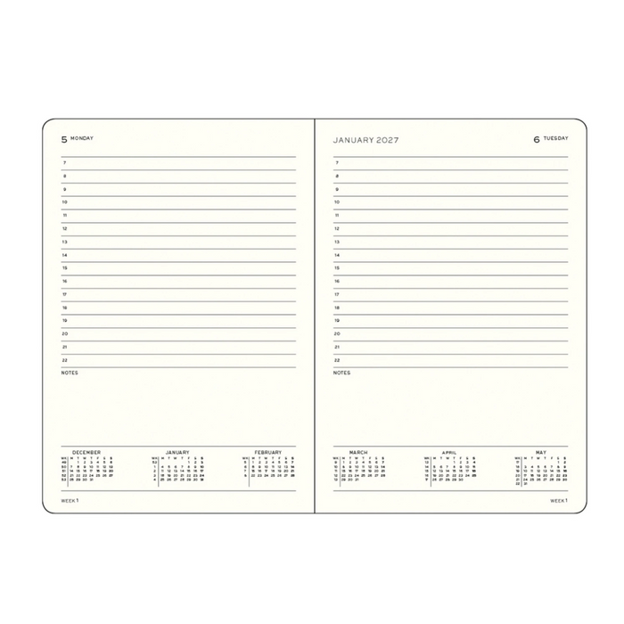 An open two-page planner showing cream-colored pages with black printed text, weekly and monthly calendar grids, and lined note sections, photographed on a plain white background.