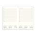 An open two-page planner showing cream-colored pages with black printed text, weekly and monthly calendar grids, and lined note sections, photographed on a plain white background.