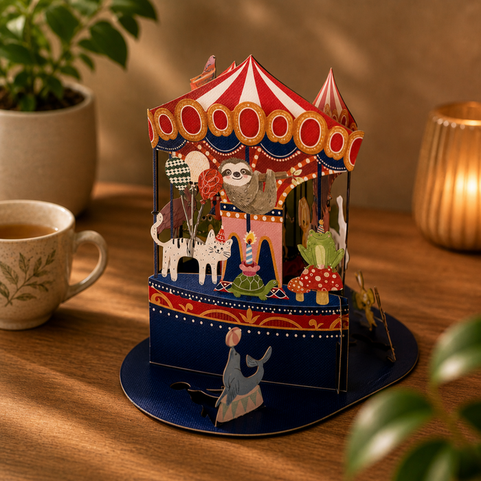 3D carousel toy with sloth character on a wooden table with a cup of tea and plant in the background