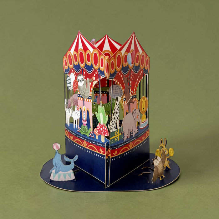 3D pop-up card with a carousel design on a green background