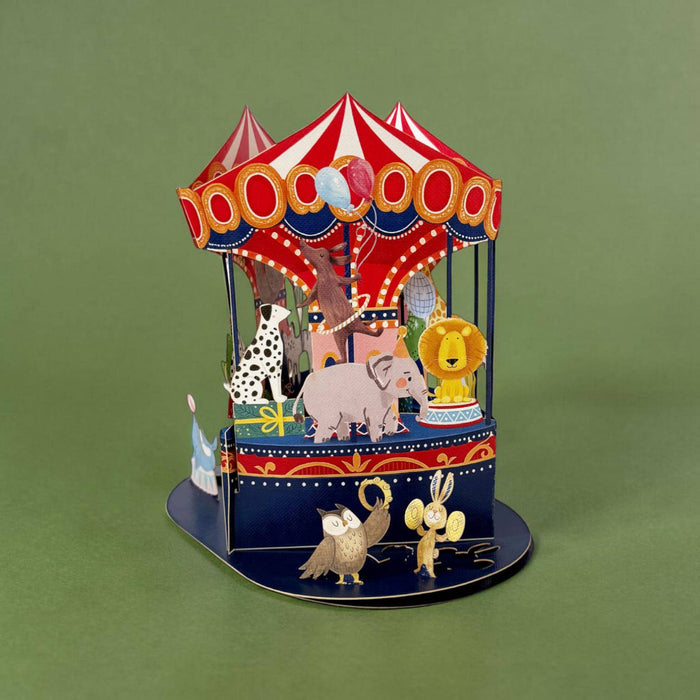Colorful carousel toy with animals on a green background