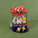 Colorful carousel toy with animals on a green background