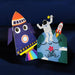 Colorful paper card of a rocket ship and an astronaut on a planet with a dark blue background
