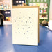 Greeting card with star pattern and 'best daddy' text on a blue surface
