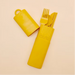Yellow cutlery set with holder on a beige background