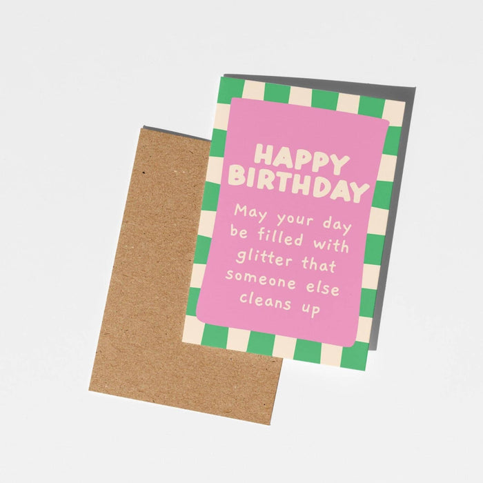Birthday card with pink and green checkered border and humorous text on a white background