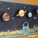 A children's educational wall display about the solar system, featuring 3D planet cutouts, an astronaut, a moon lander, and a rocket against a dark space background with an orange border. The Clockwork Soldier brand logo is visible in the bottom right corner.