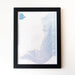 A framed art print titled 'THE EAST COAST MAP' featuring layered blue and purple line patterns on a white background, enclosed in a black frame and mounted on a light wall.