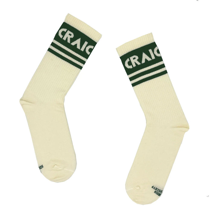 pair of white socks with3 green bands on ankle and craic in white lettering in the thickest green band