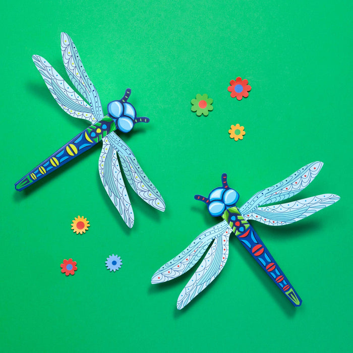 Colorful dragonfly-shaped objects on a green background