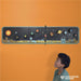 Child looking at a create-your-own solar system paper craft kit with various planets and a sun illustration on it.