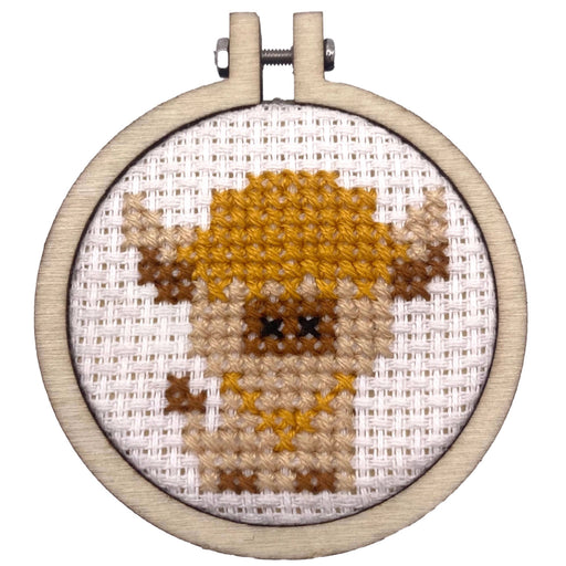cross stitch embroidery hoop featuring cow design