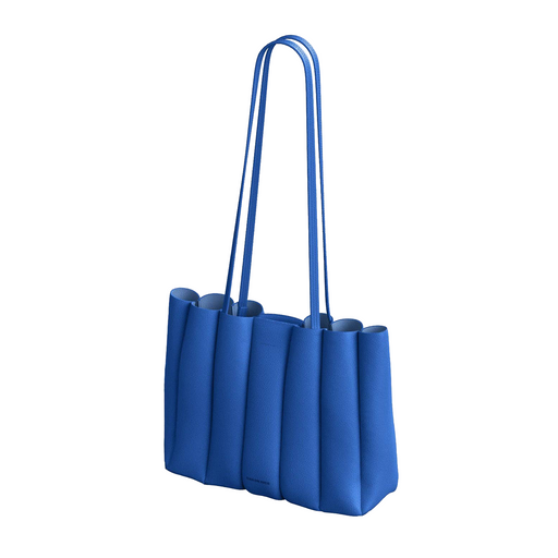 A vibrant blue leather tote bag with a unique pleated, accordion-like design and long shoulder straps, shown against a plain white background.