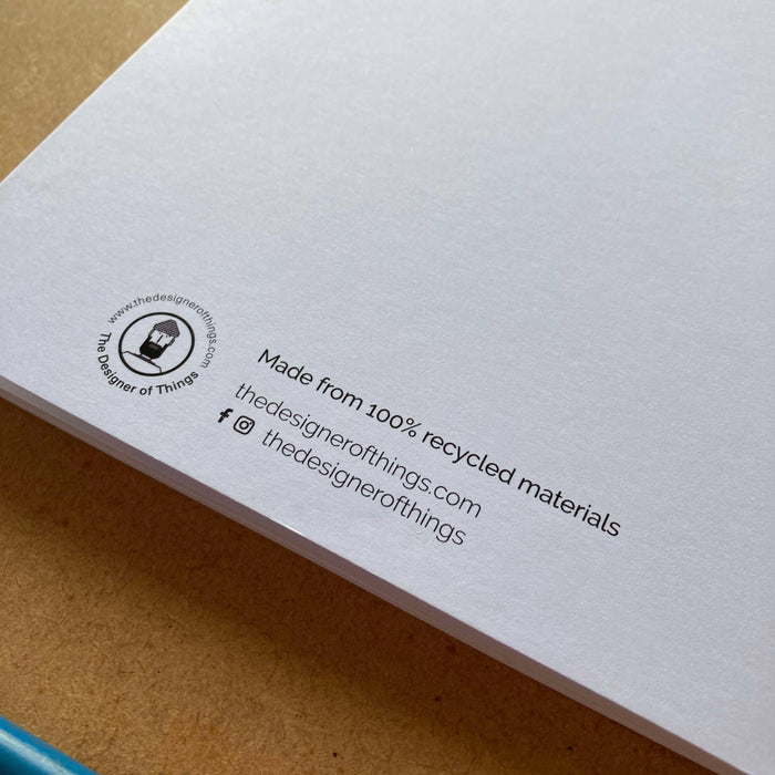 Back cover of notebook with recycled materials information and branding details.