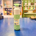 Mint green and white water bottle with 'dopper' branding on a blue surface, store shelves in the background.