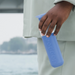 model holding dopper pacific blue bottle against a water front