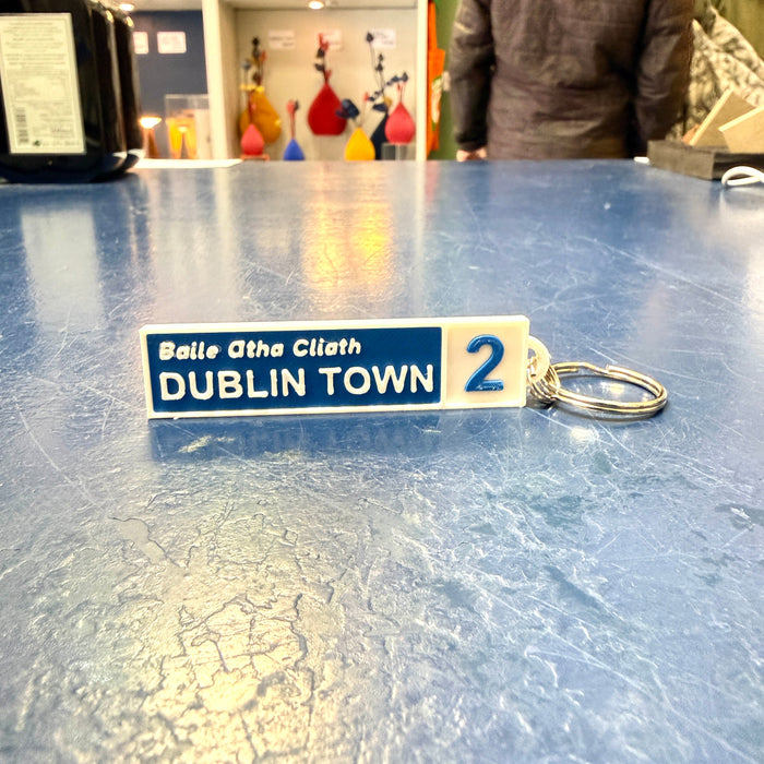 Keychain with 'Dublin Town' text on a blue surface