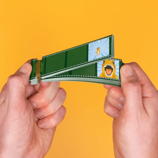 Two hands holding a green film strip camera that projects illustrated movie scenes, set against a solid yellow background.
