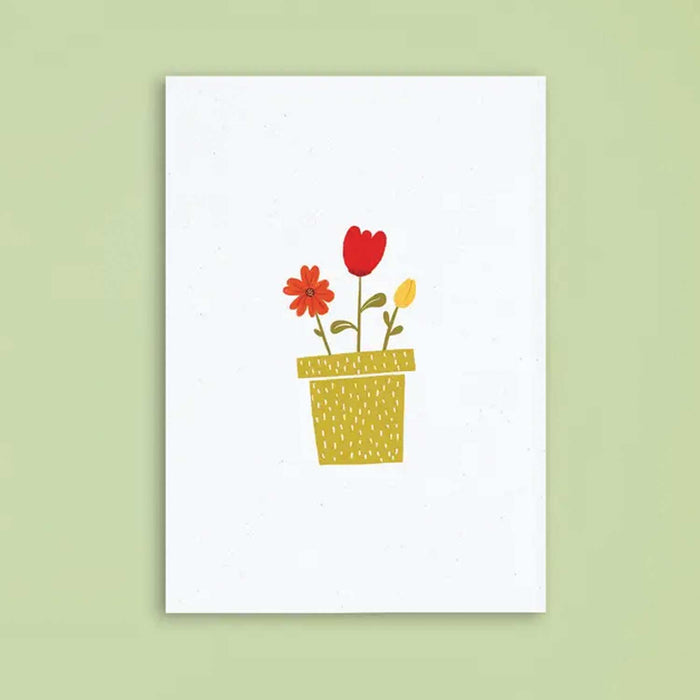 white greeting card with no text and drawing of plant pot with 2 red flowers and 1 yellow flower in it card is against a green background