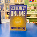 Book titled 'Extremely Online' by Taylor Lorenz on a blue surface with a store background.