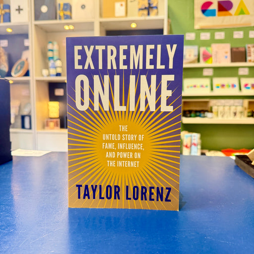 Book titled 'Extremely Online' by Taylor Lorenz on a blue surface with a store background.