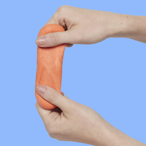 Two hands pulling apart orange putty against a blue background