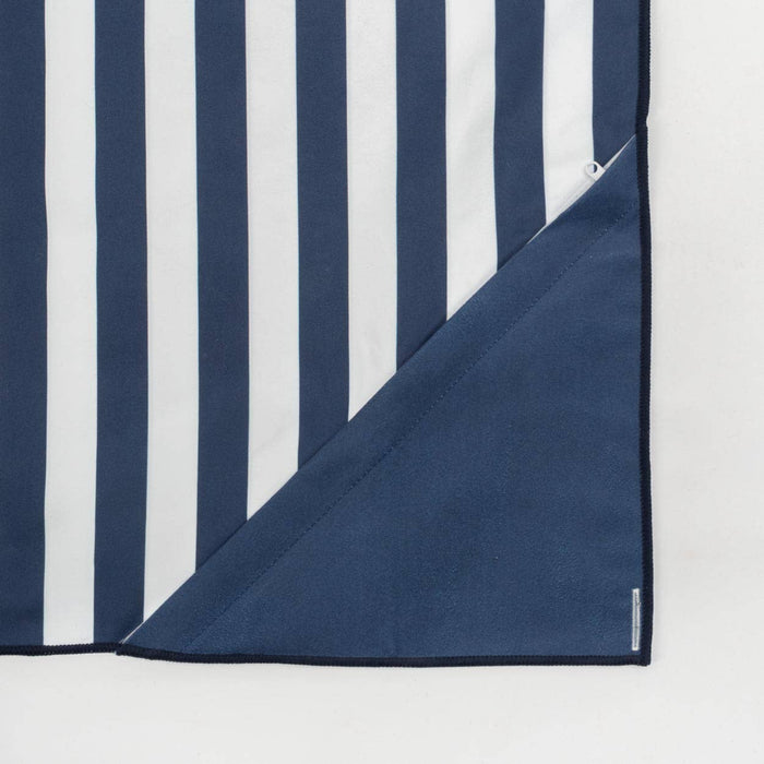 Corner of navy and white striped towel on a light gray background