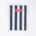 Navy and white striped towel with 'Flamingueto' label on a white background