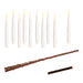 White candles with a brown magic wand on a white background