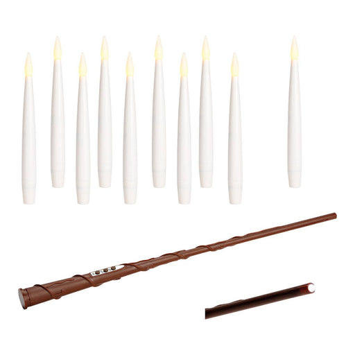 White candles with a brown magic wand on a white background