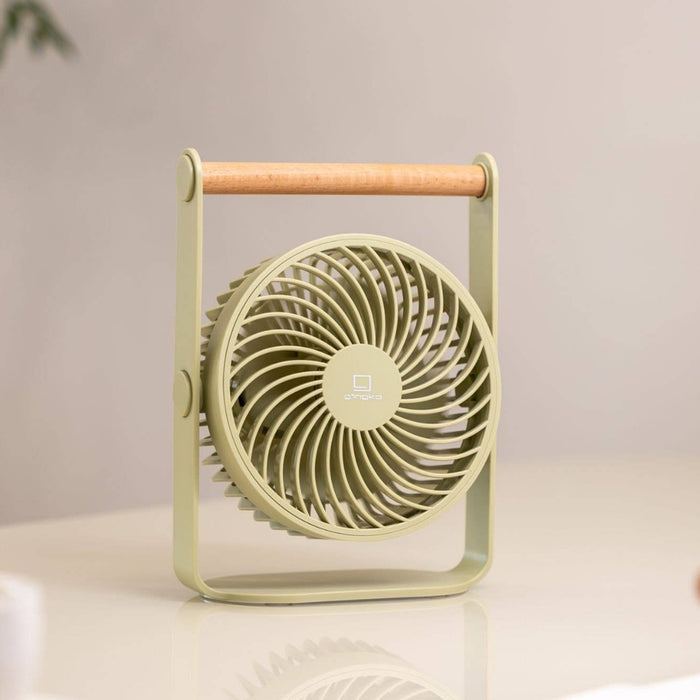Portable fan on a desk with a blurred background