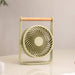 Portable fan on a desk with a blurred background