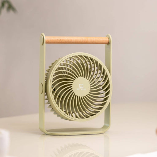 Portable fan on a desk with a blurred background