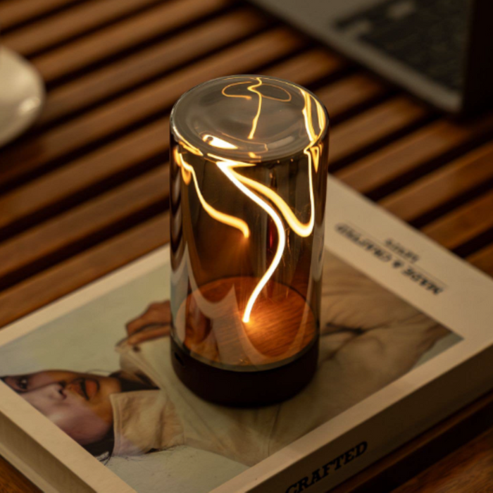 Decorative lamp with a warm glow on a book.