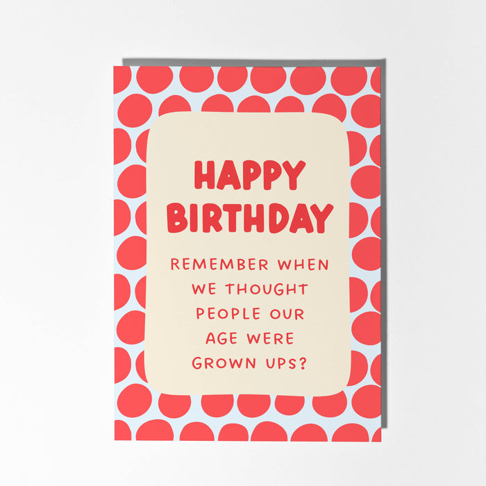 Birthday card with red text and patterned border on a light gray background