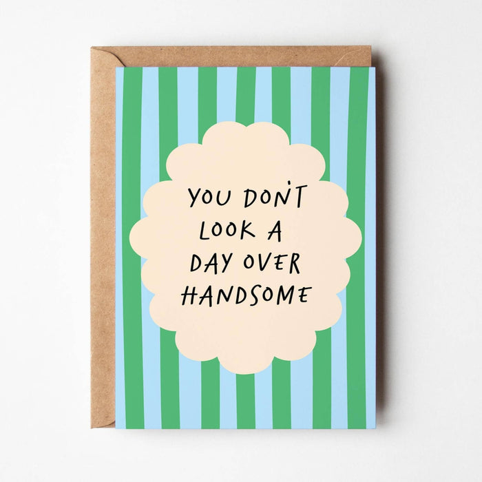 Greeting card with striped design and humorous text on a white background