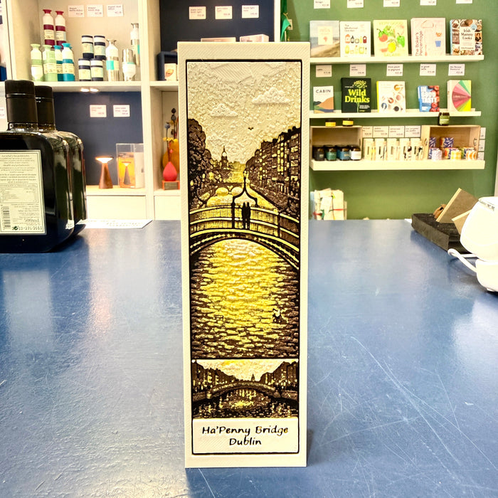 Luminous bookmark with a design of Ha'Penny Bridge in Dublin on a blue surface.