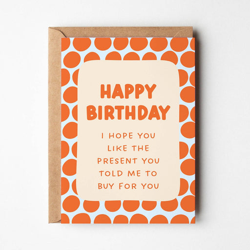 Birthday card with orange polka dot pattern and humorous text on a white background