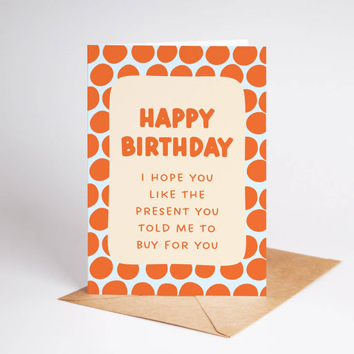 Birthday card with orange pattern and humorous message on a white background