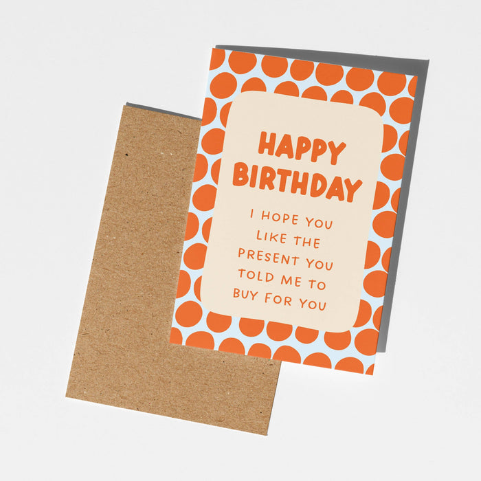 Birthday card with orange polka dots and a humorous message on a white background