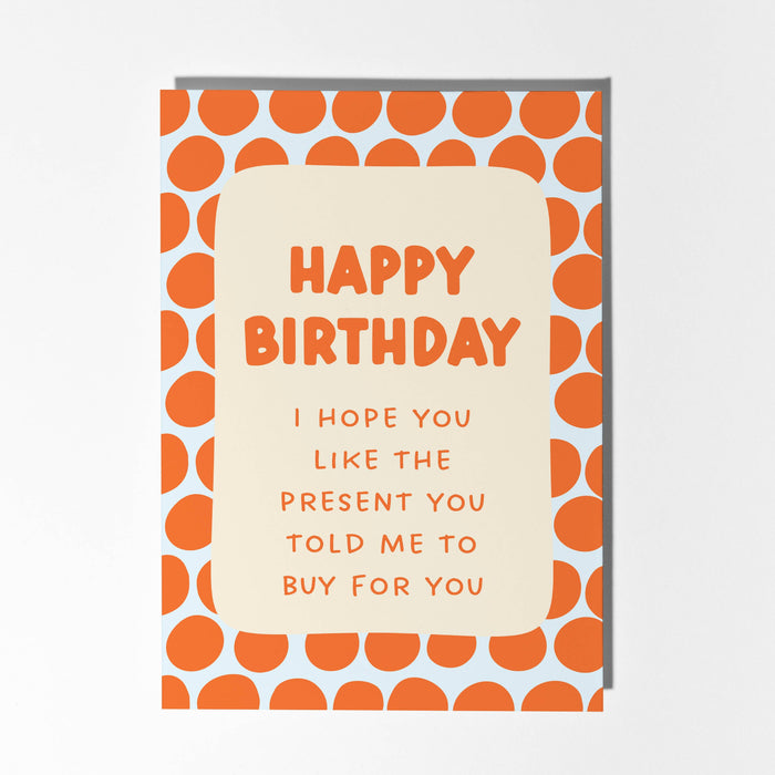 Birthday card with orange polka dot border and humorous message on a light gray background