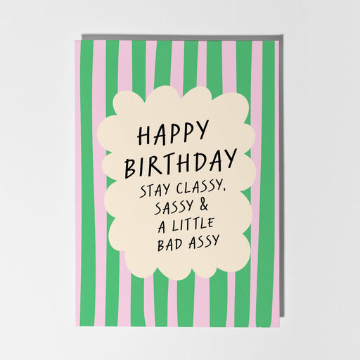 Birthday card with green and pink striped background and humorous text