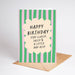 Birthday card with green and pink striped design and humorous text on a white background