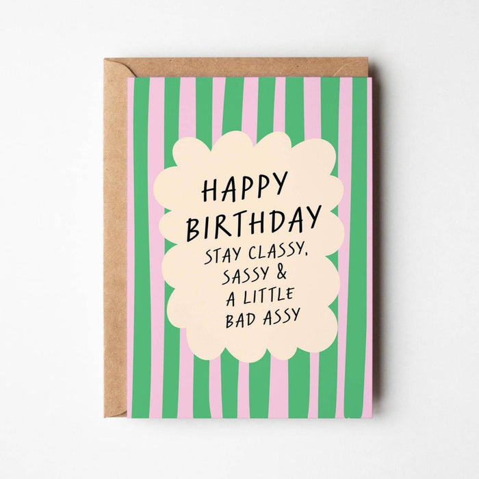 Birthday card with green and pink striped design and humorous text on a white background