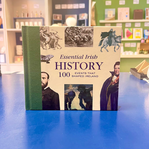 Book titled 'Essential Irish History: 100 Events That Shaped Ireland' on a blue surface with a store background.